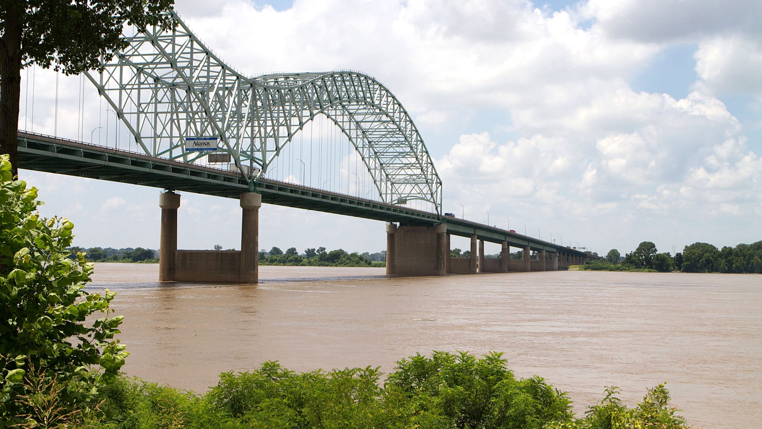 The Interstate 40 bridge over the muddy brown water of the Mississippi River connects Memphis, Tennessee, and West Memphis, Arkansas.